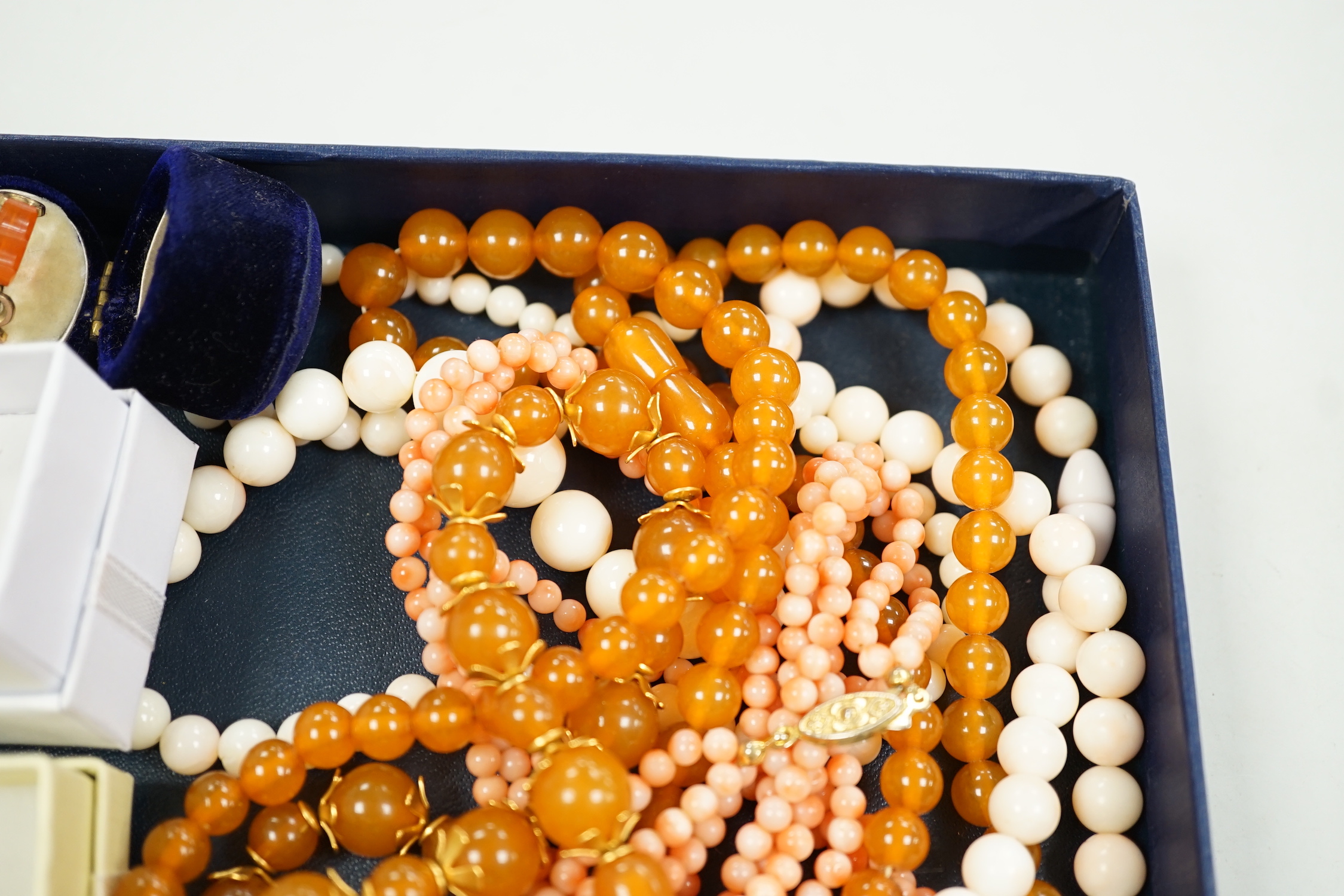 A 9ct and opal doublet ring, two other 9ct and gem set rings, an Edwardian yellow metal and swivelling carnelian ring and six assorted necklaces.